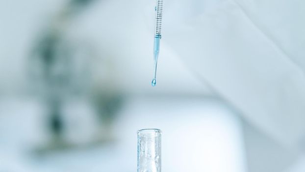 close up. background image of a scientist testing a liquid in a tube . photo with a copy-space.