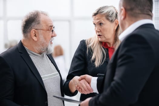 close up. businessman and businesswoman greeting each other with a handshake . the concept of cooperation