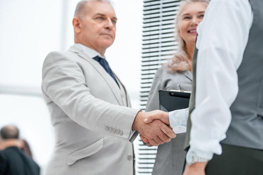 close up. serious business man shaking hands with his colleague. the concept of cooperation