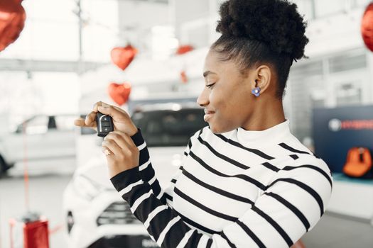 Went shopping today. Shot of an attractive African woman shows the keys to the camera.