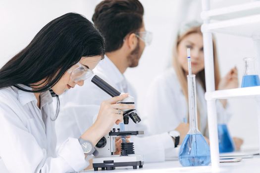 female scientist uses a microscope in the laboratory. science and health