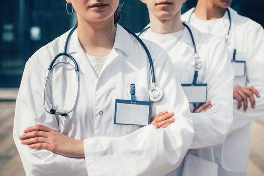 close up. group of medics with blank badges standing in a row. photo with a copy-space.