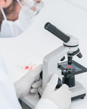 close up. scientist uses a microscope in a modern laboratory. photo with a copy-space.