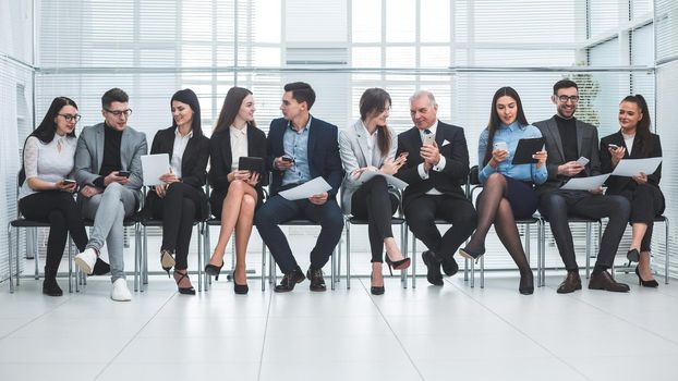 group of employees using their devices in the conference room. photo with a copy of the space