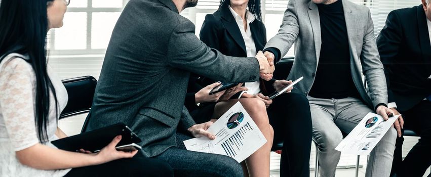 business colleagues shaking hands at an office meeting. concept of cooperation