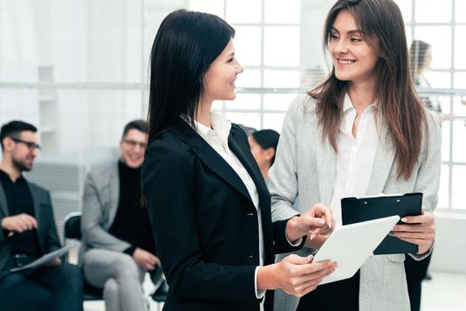 business colleagues discussing business documents standing in the office. business concept