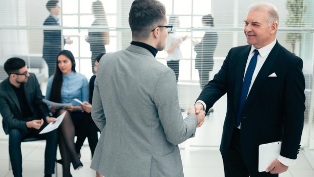 businessmen shake hands standing in the conference room. concept of cooperation