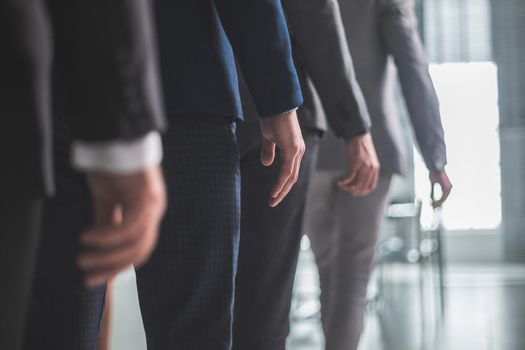 close up. office employees passing through the office. business concept