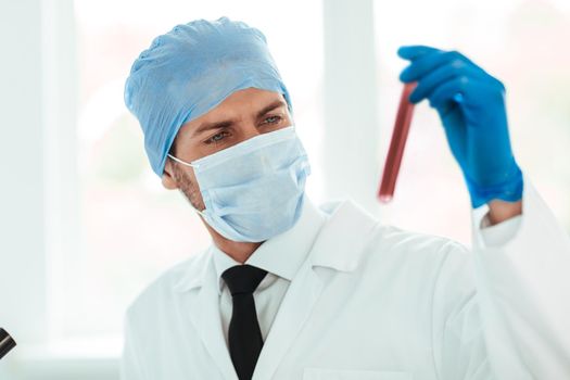 close up. test tube in the hands of the scientist. the concept of health.