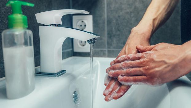 close up. soap suds on the hands of a young man . concept of prevention of infectious diseases.