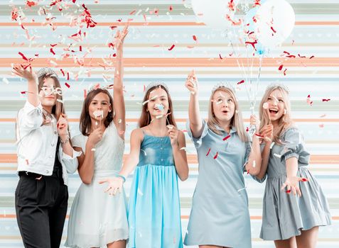 Happy girls at birthday party with balloons and confetti