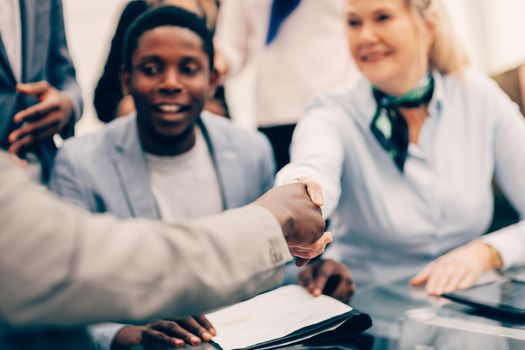 close up. smiling international business partners shaking hands. the concept of cooperation