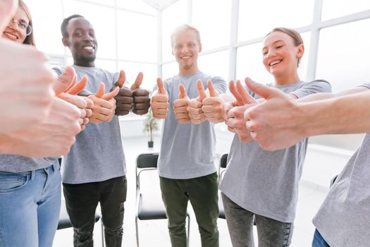 close up. smiling group of young people standing in a circle. success concept