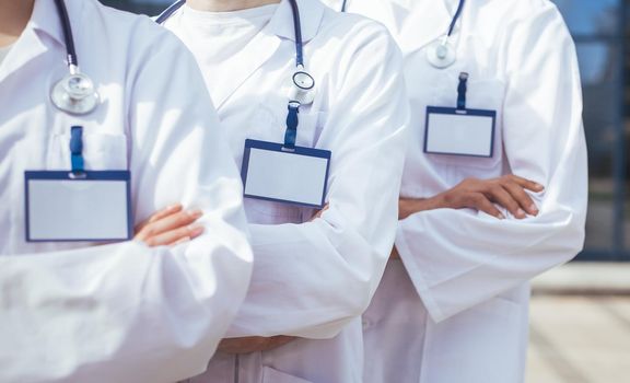 close up. group of medics with blank badges standing in a row. photo with a copy-space.