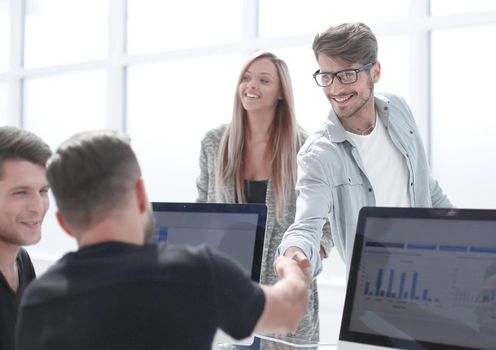 Welcome to our team! young modern man wear shaking hands while working in the creative office