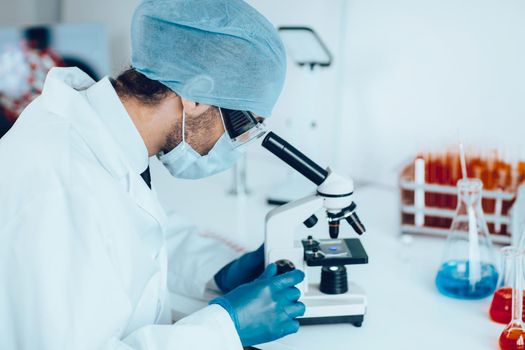 close up. talented scientist sitting at a table in the laboratory.