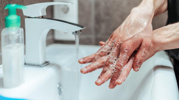 close-up. person carefully soaping his hands . the concept of prevention of infectious diseases.