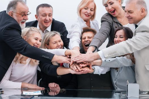 close up. a group of company employees making a tower out of their hands . the concept of teamwork