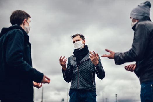 close up. young people in protective masks communicate on a city street