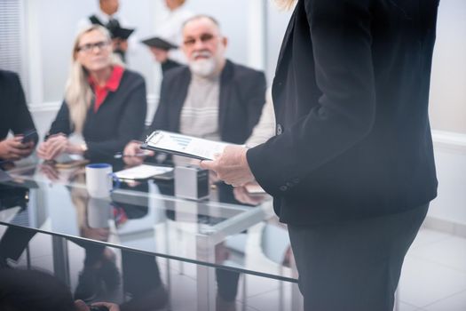 close up. the Manager makes a report at a meeting in the office. business concept