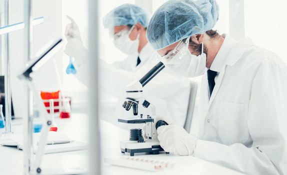 close up. scientist using a microscope in the laboratory . photo with a copy-space.