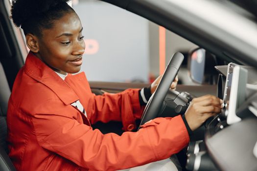 Went shopping today. Shot of an attractive African woman sitting in a car salon.