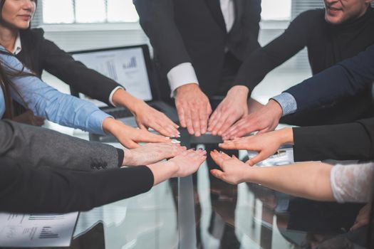 close up. business team making a circle out of their palms. the concept of teamwork