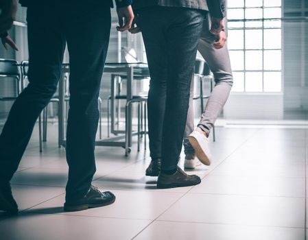 close up. office employees entering the work office. business concept