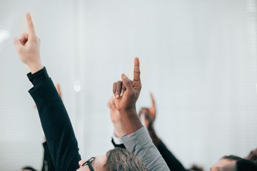 group of business people pointing up at a copy of the space. business background