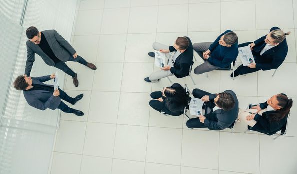 top view. boss congratulating the best employee during a work meeting.