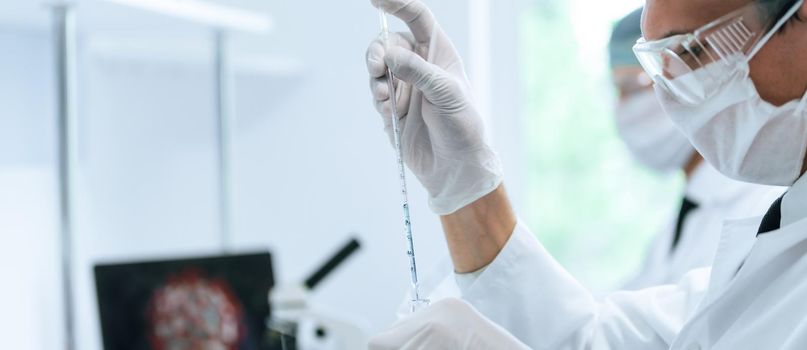 close up. a group of scientists work in a modern laboratory. photo with a copy of the space.