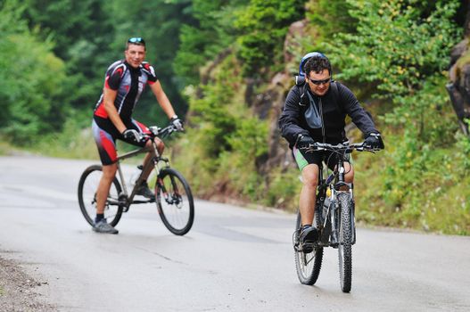 two friends have fun outdoor in nature and representing concept of  healthy life and fitnes on muntain bike