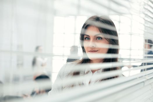 young business woman standing near office window. photo with copy-space