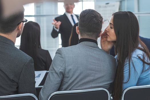 rear view. employees discuss something during a business seminar