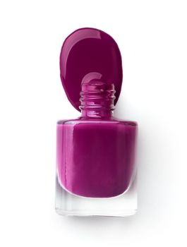 Violet splash from nail polish bottle isolated