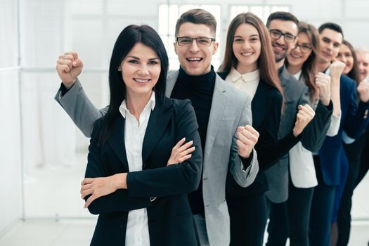 happy group of diverse young people standing in a row . the concept of teamwork