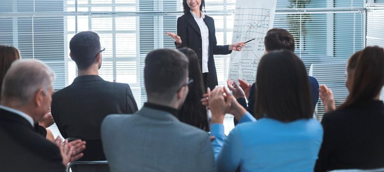 rear view. businesswoman making a presentation for the employees of the company