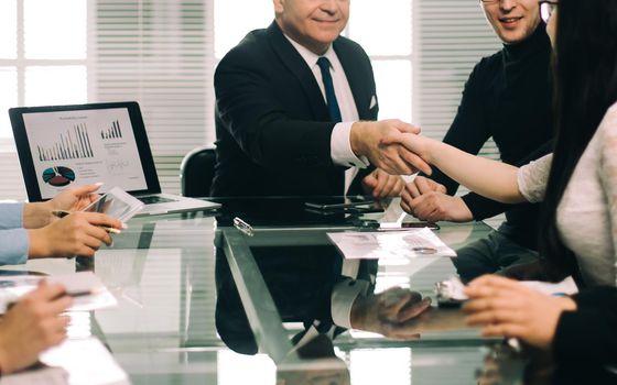 business colleagues shaking hands during a work meeting. the concept of teamwork