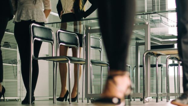 close up. a variety of business people passing through the office business center. business background