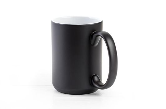 Black ceramic cup with white inside on a white background