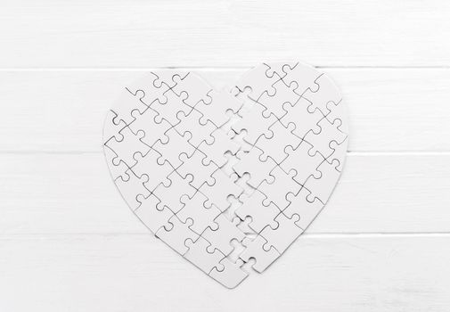 Bold heart shaped puzzle on white table