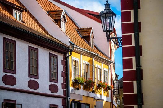 Colorful houses decorated with flowers on street in Czech Krumlov