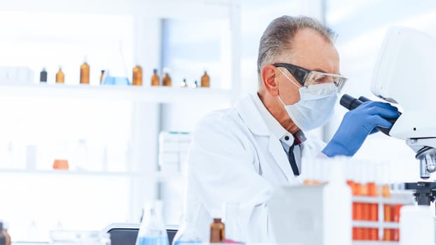 close up. scientist in a protective mask conducts research in the laboratory. science and health protection.