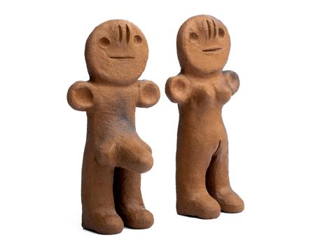 Ancient clay male and female figurines from Canary Islands isolated on white background