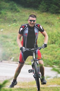 healthy lifestyle and fitness concept with mount bike man who ride bike  outdoor