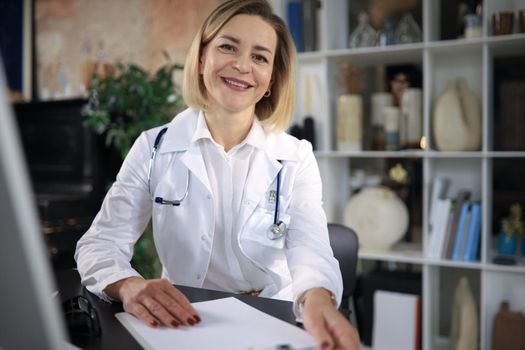 Middle aged female doctor therapist on consultation
