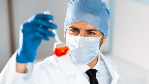 close up. medical flask in the hands of a laboratory assistant. science and health.