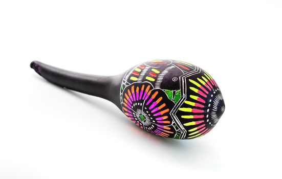 Painted maracas lying on white background
