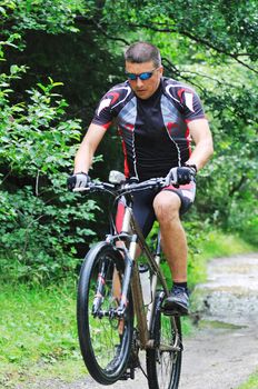 healthy lifestyle and fitness concept with mount bike man who ride bike  outdoor
