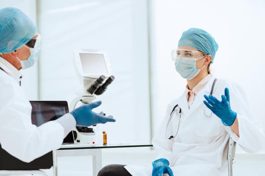 close up. biologists discussing something in the lab. photo with a copy-space.